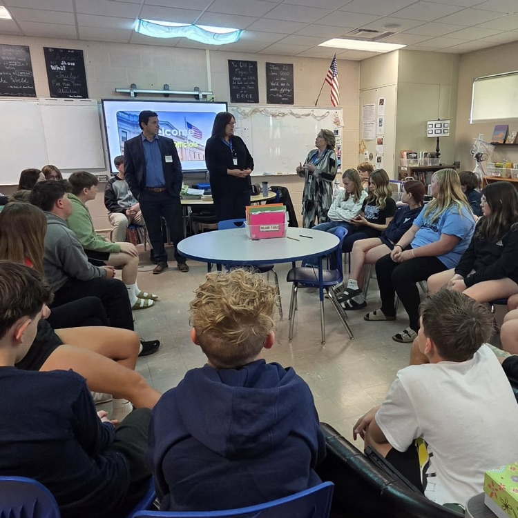 adults speaking in a classroom of kids
