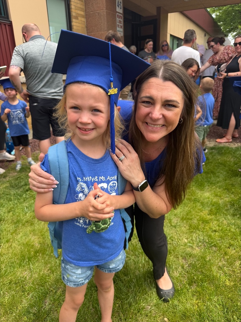 woman posing with preschooler in blue graduation cap