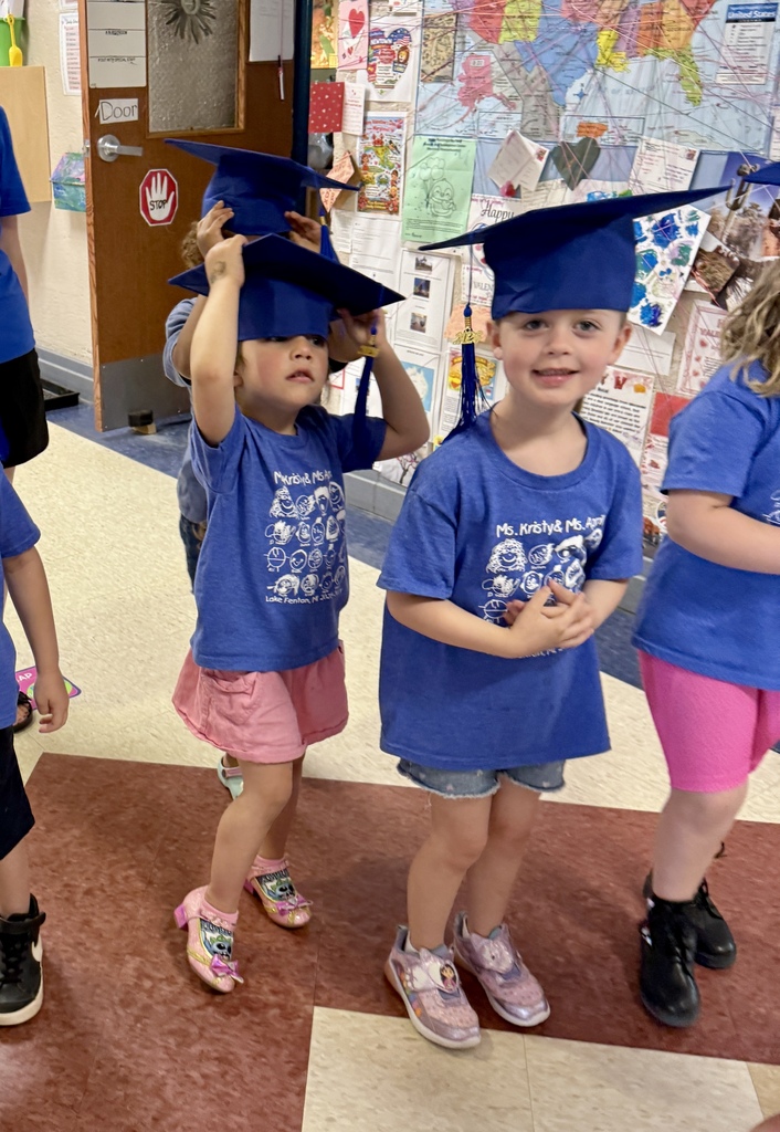 preschoolers in blue graduation caps