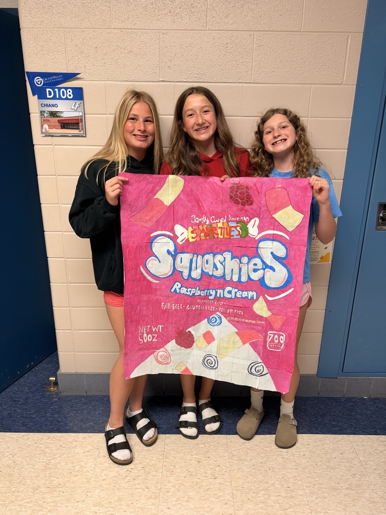3 girls holding giant drawing of a Squashies cany bag