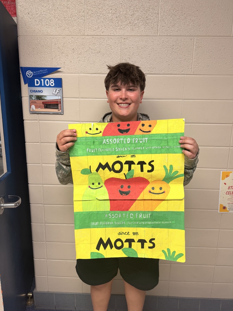 boy holding large drawing of a Mott Fruit snack bag