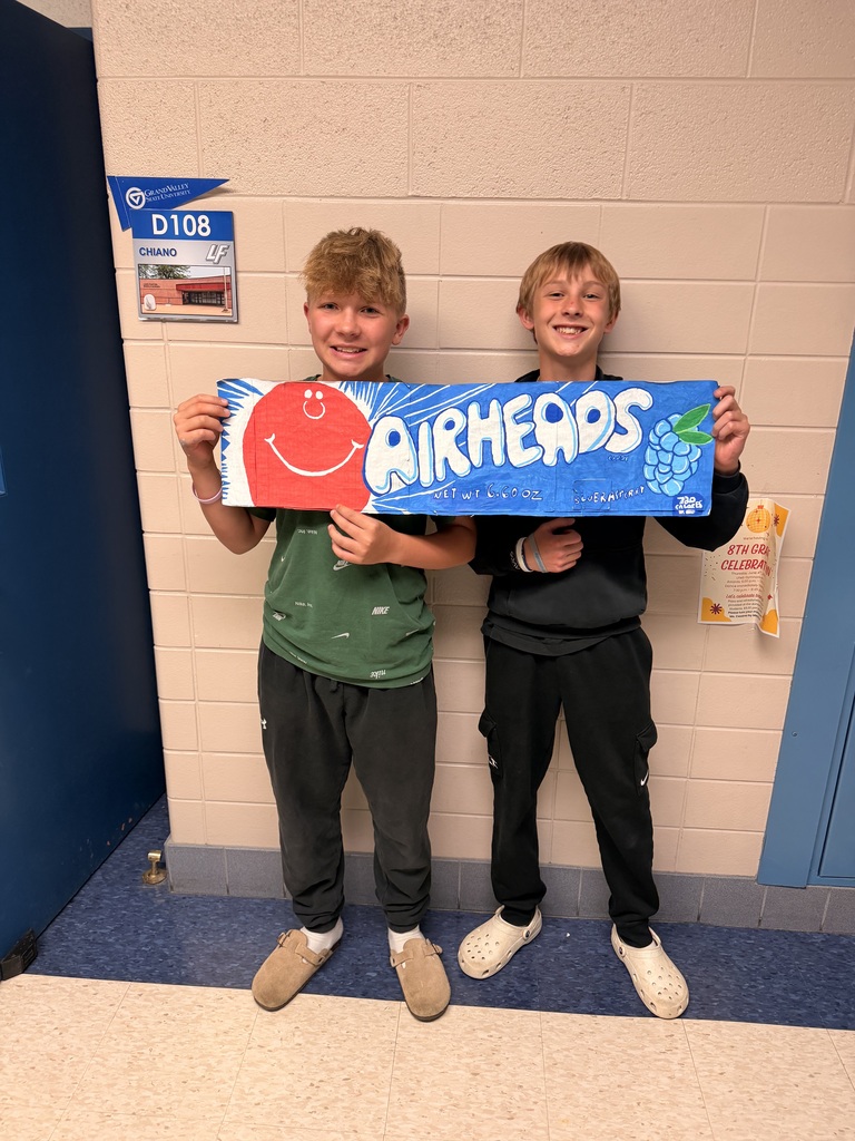 2 boys holding giant drawing of Airheads candy wrapper
