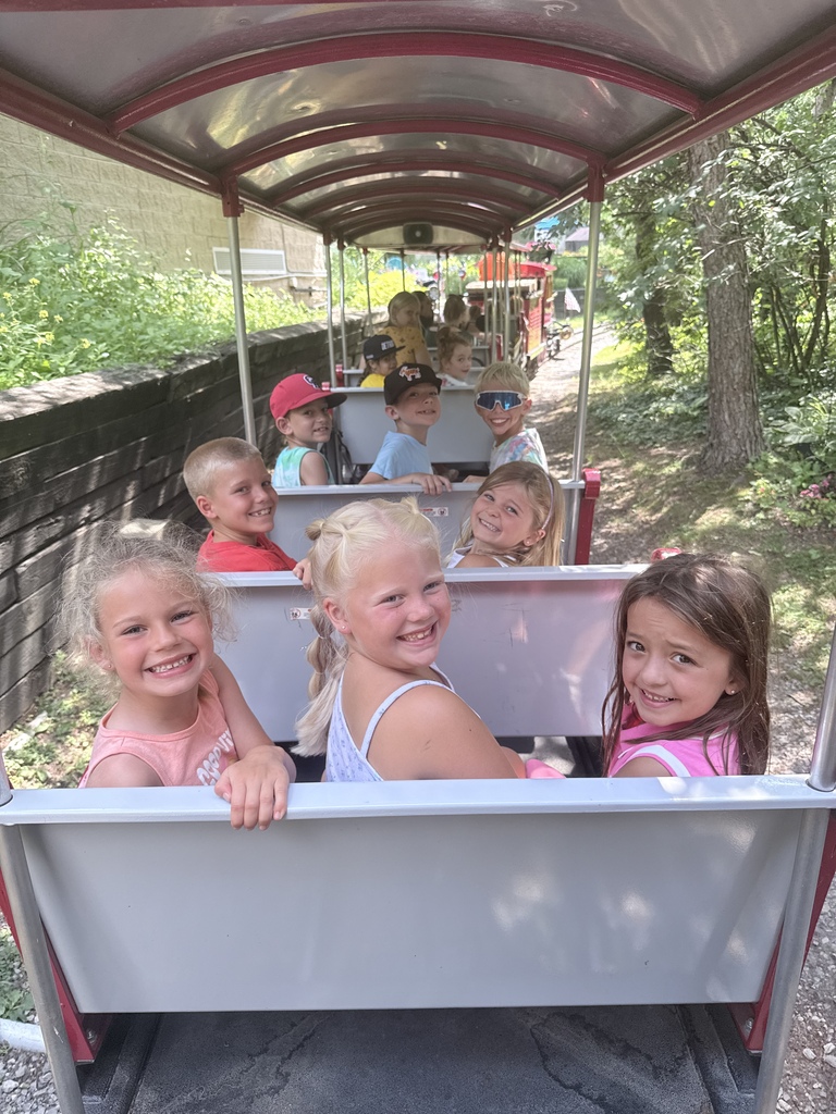 children posing on a train ride