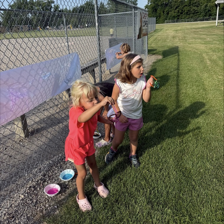 group of kids outside making bubbles