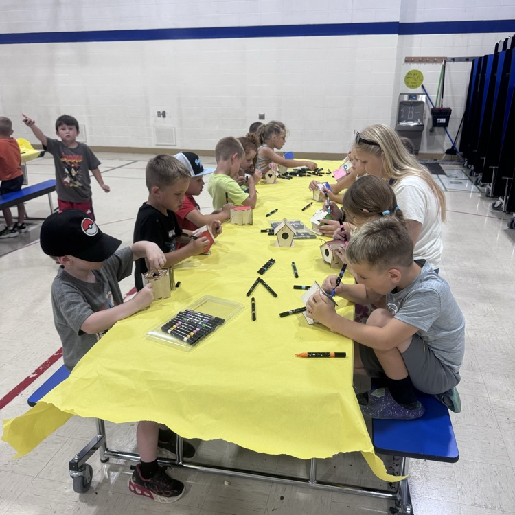 a table full of kids doing crafts