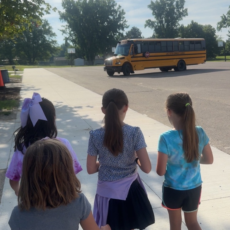 girls walking toward a bus