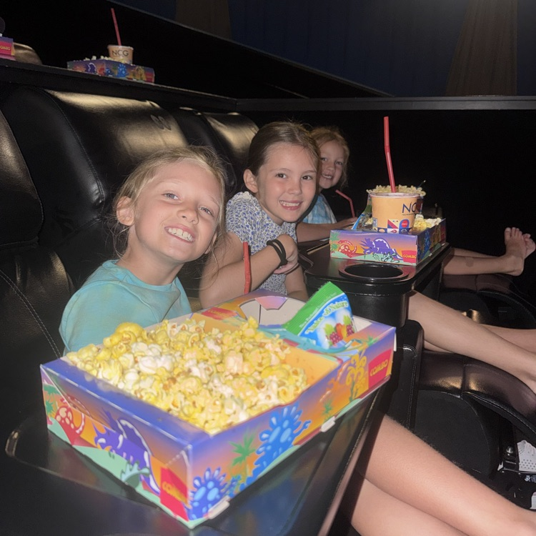 kids eating popcorn in a movie theater