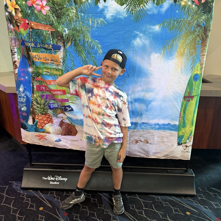 boy posing in front of a Hawaiian backdrop