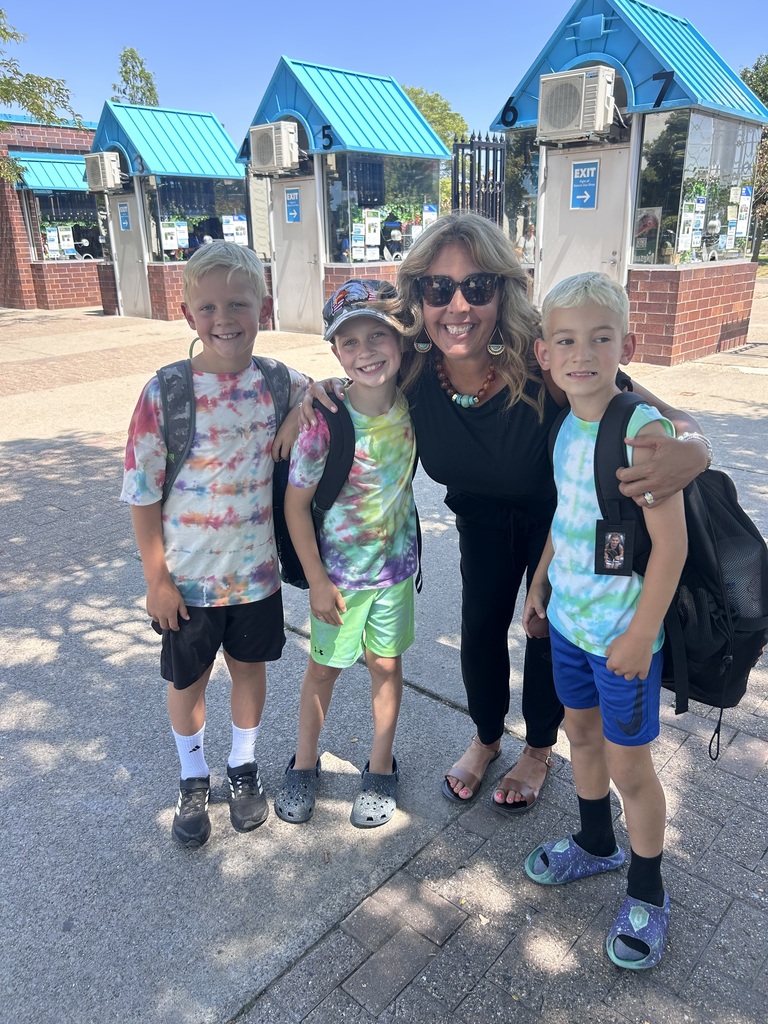 3 boys posing with woman outdoors