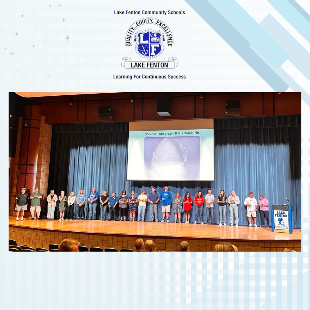 large group of people on a stage holding awards