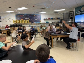 teacher In front of students in a STEM classroom