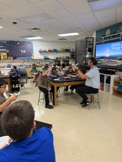 teacher In front of students in a STEM classroom