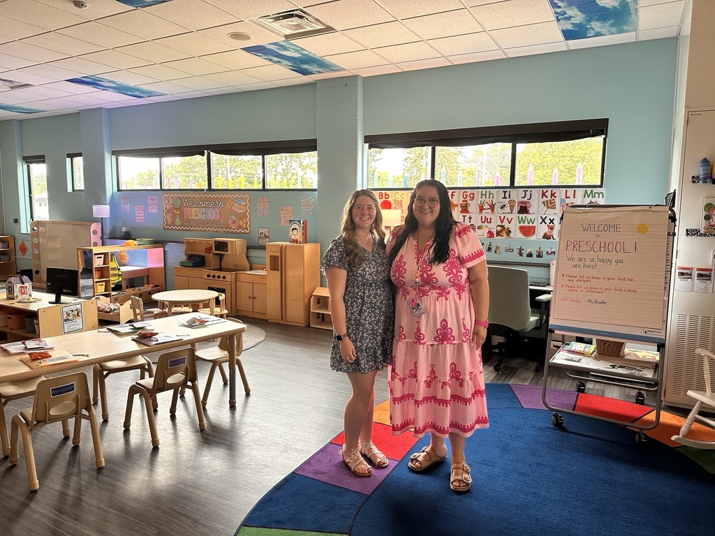2 women posing in a preschool classroom