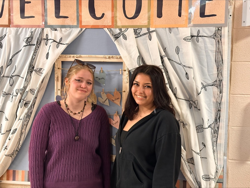 2 women posing in a preschool hallway