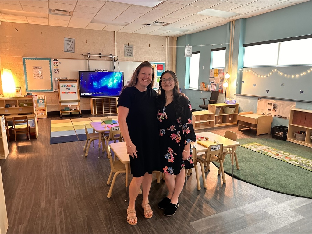 2 women posing in a preschool classroom