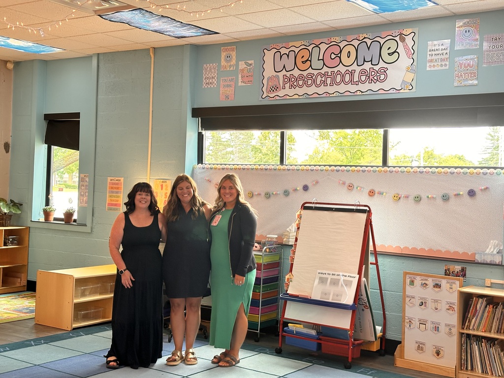 3 women posing in a preschool classroom