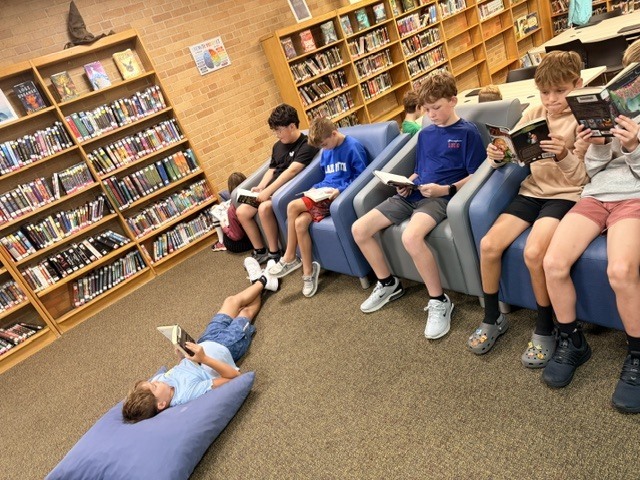 a group of students reading in a library
