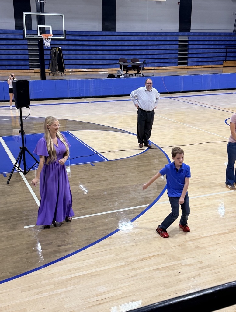 teachers and students dancing in a gym