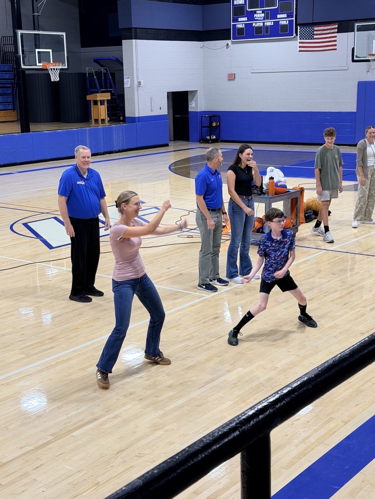 teachers and students dancing in a gym