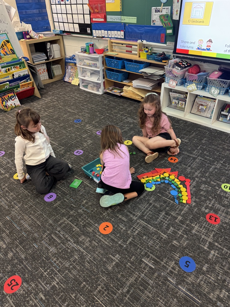 kids playing with brightly colored blocks on a classroom floor