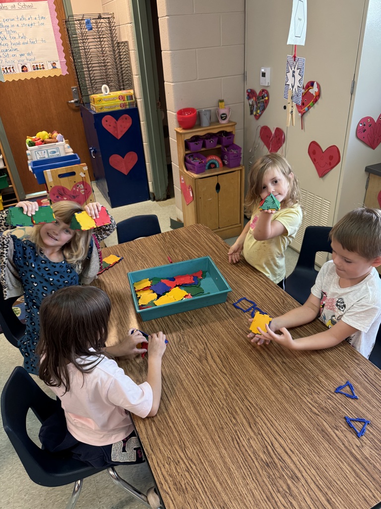 kids playing with brightly colored blocks in a classroom