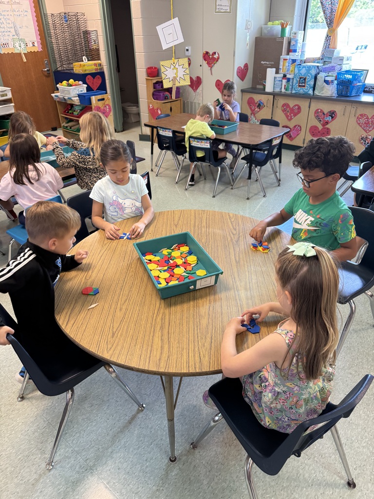 kids playing with brightly colored blocks in a classroom