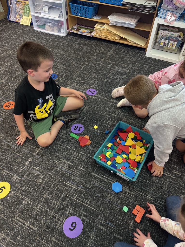 kids playing with brightly colored blocks on a classroom floor