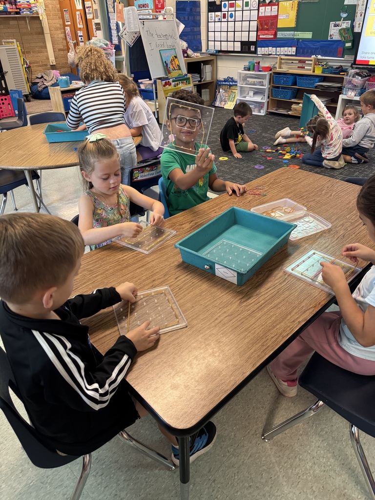 kids playing with brightly geoboards in a classroom