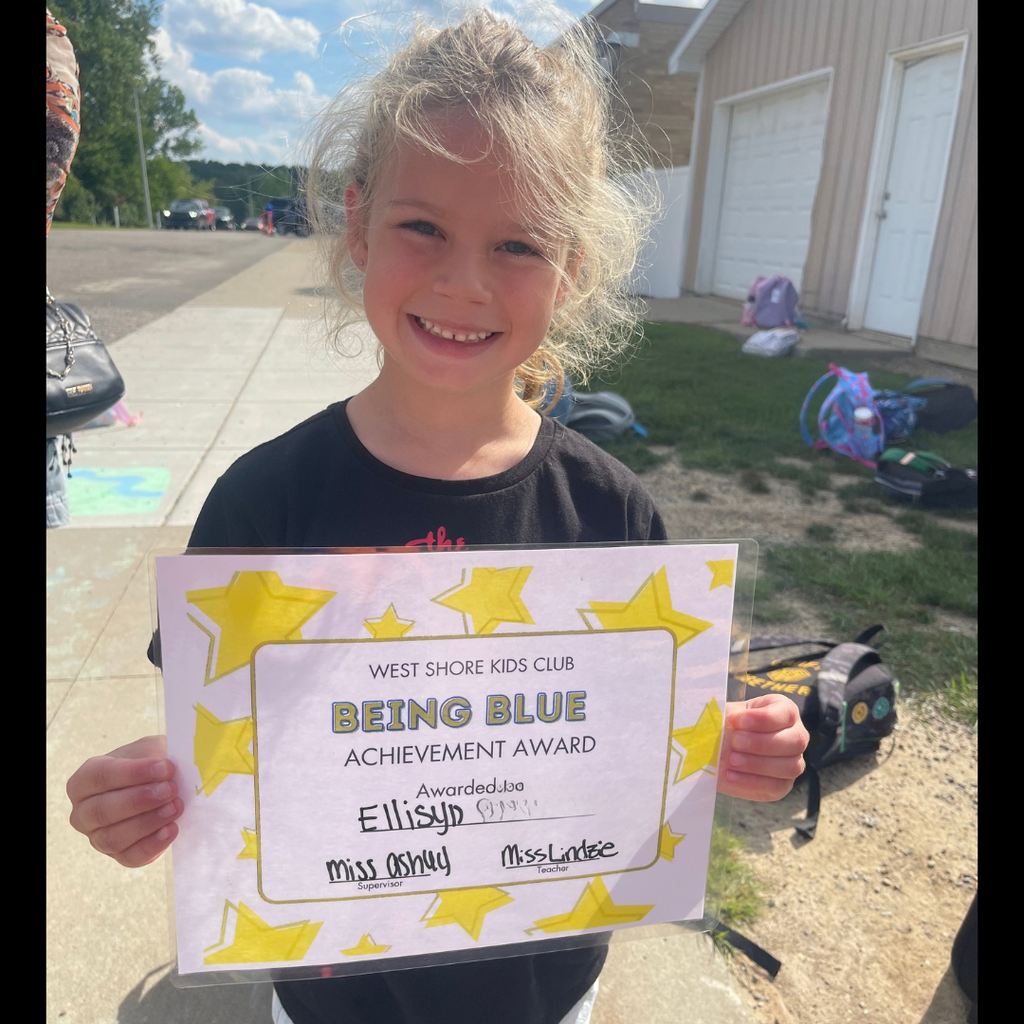Girl smiling and holding a Being Blue Achievement Certificate