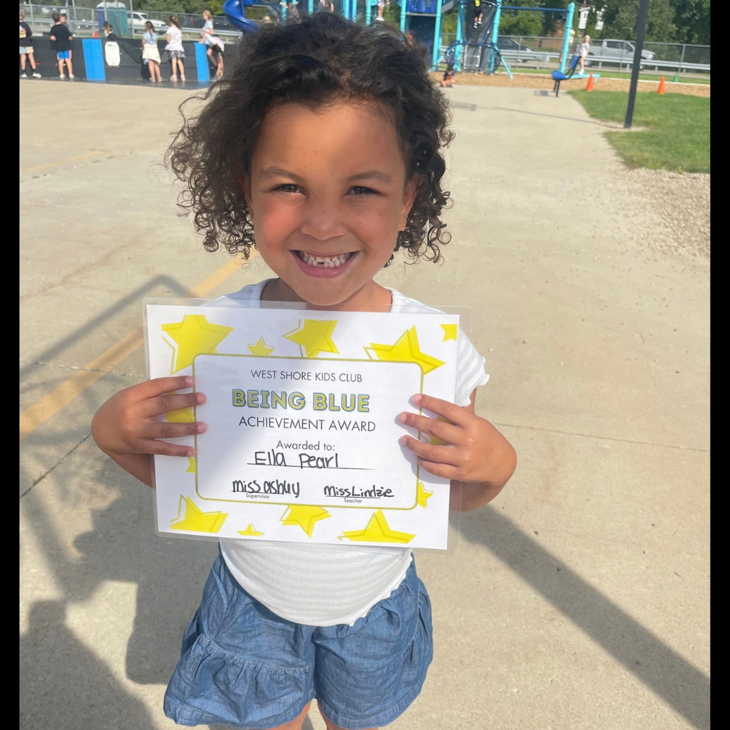 Girl smiling and holding a Being Blue Achievement Certificate