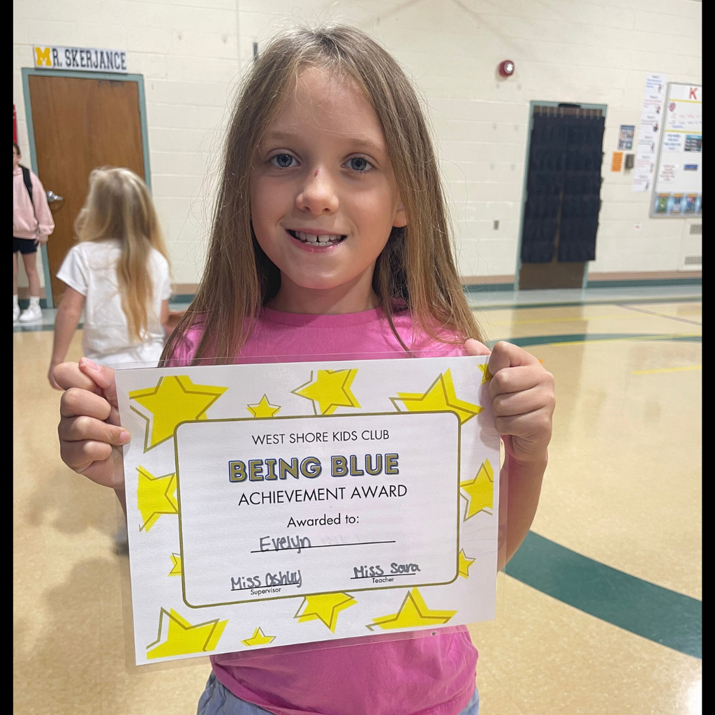 Girl smiling and holding a Being Blue Achievement Certificate