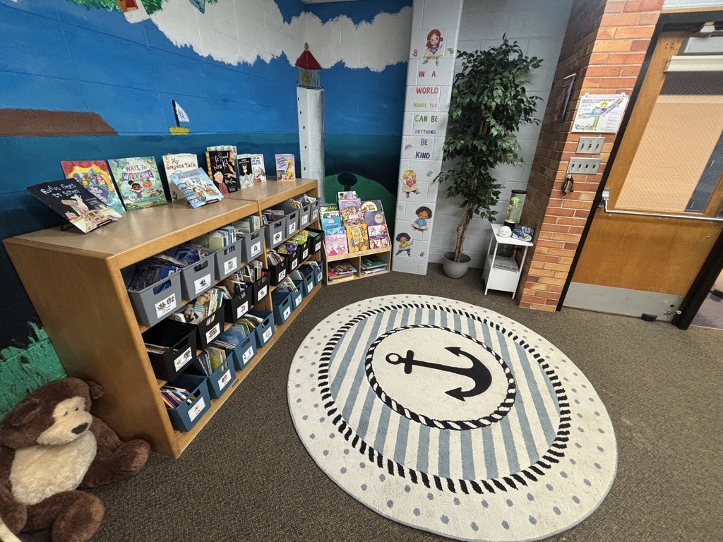 small area in a library with a blue rug with an anchor on it