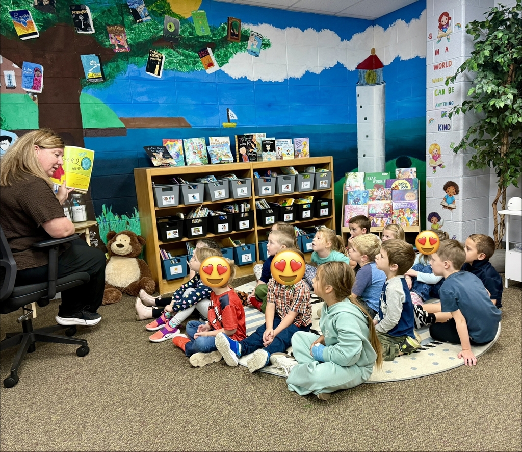 woman reading to group of students