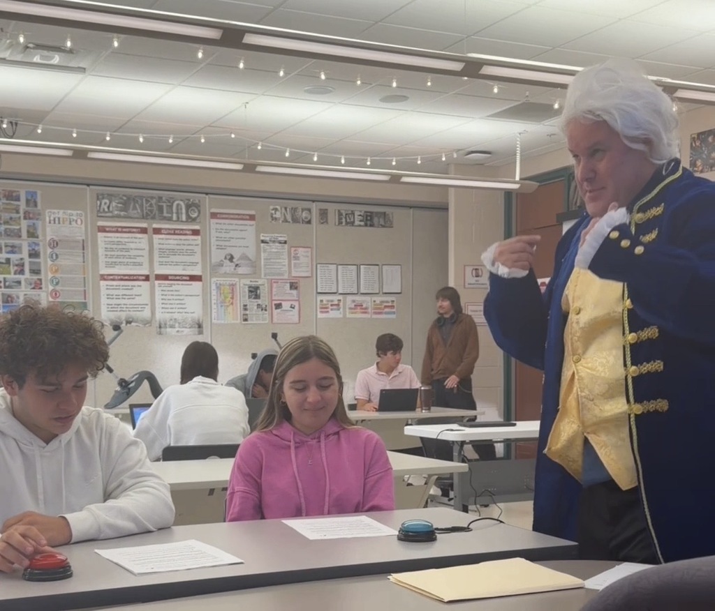 man dressed like James Madison quizzing students in a classroom