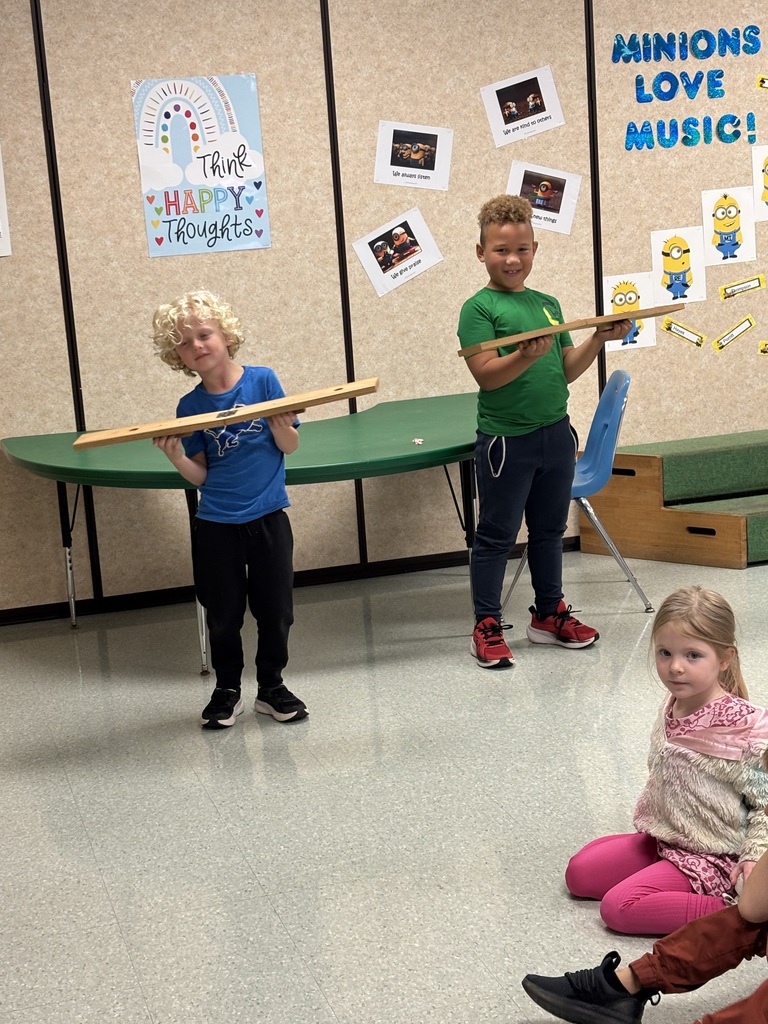 2 children playing with slapsticks in music class
