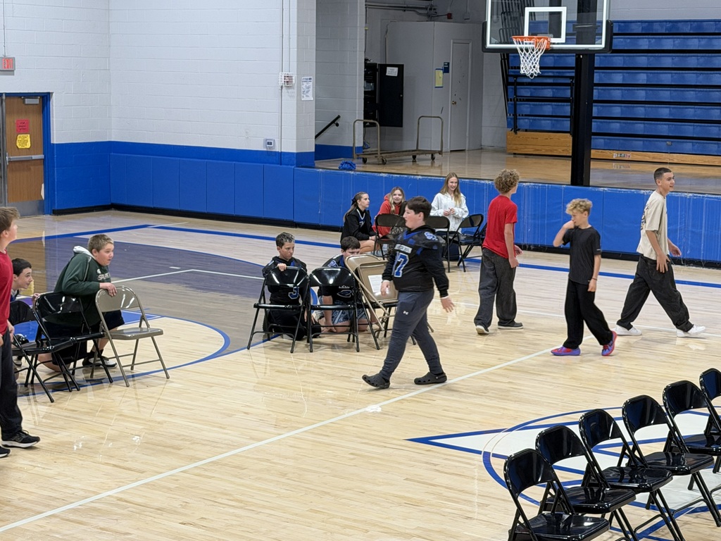 Group of students walking around a school gym