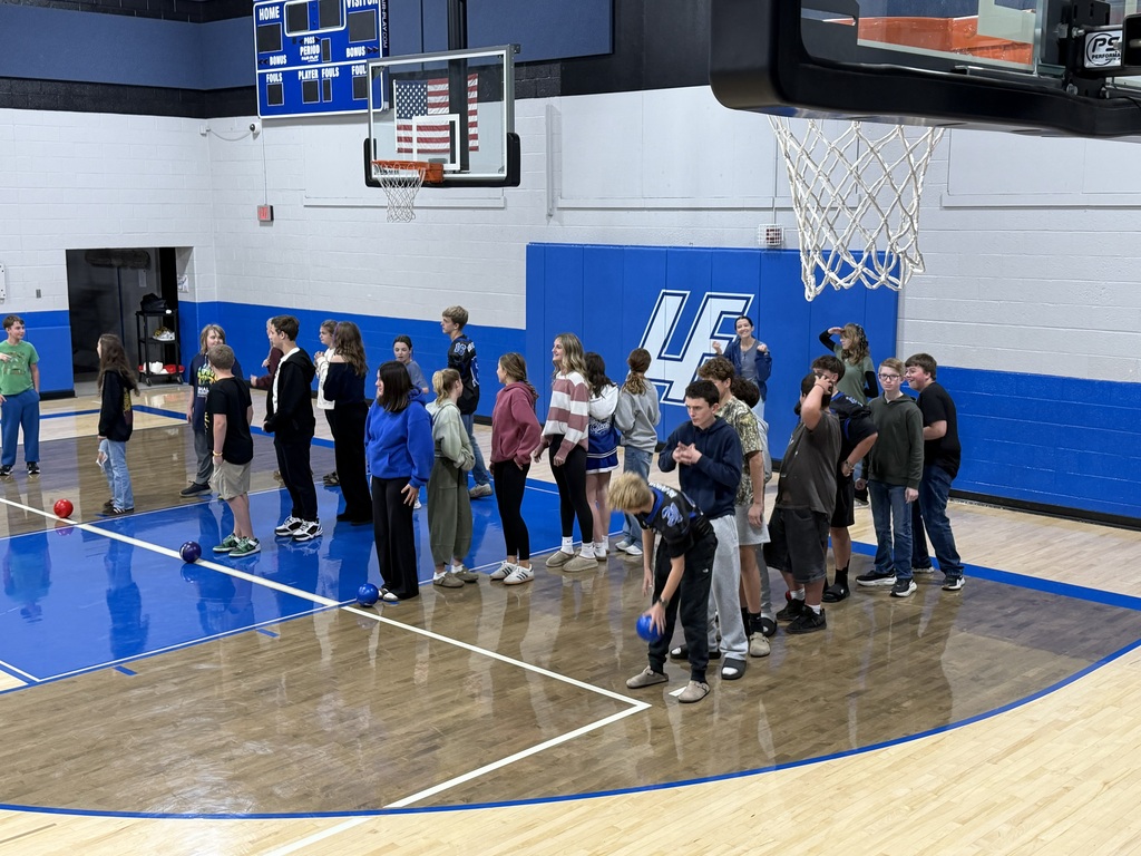 groups of students standing in lines in a school gym