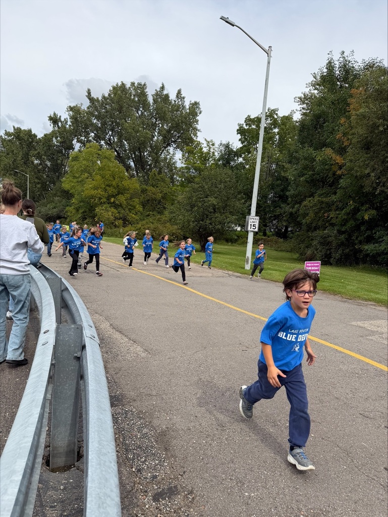 group of children running wearing blue tshirts