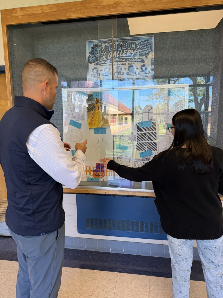 man and girl looking at art in a glass cabinet