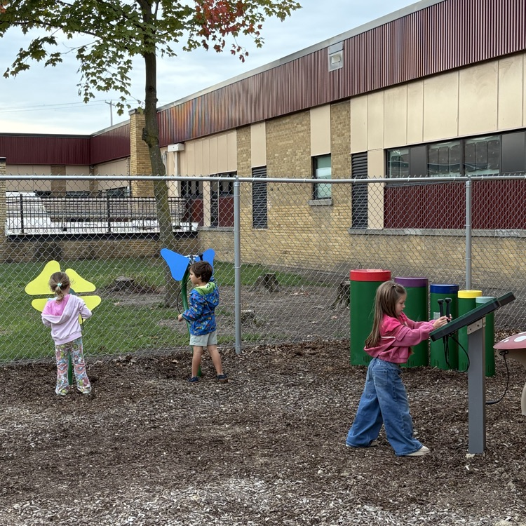 kids playing on a playground outside a school