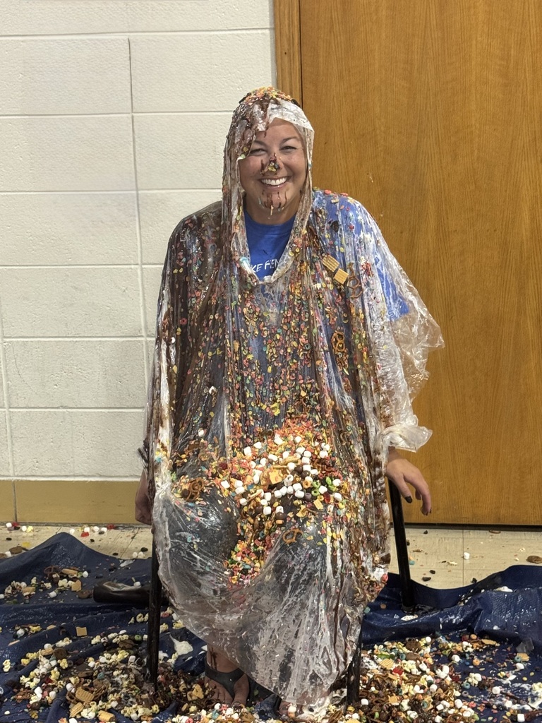 woman smiling and covered in ice cream toppings