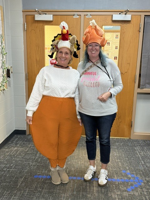 2 women wearing turkey hats