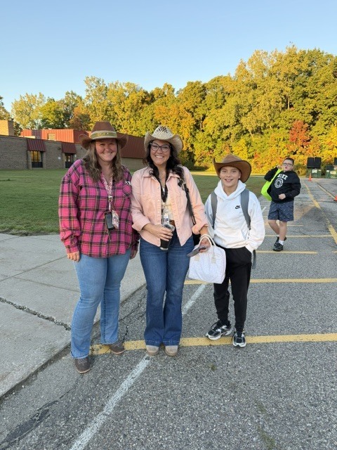 2 women and 1 boy posing wearing cowboy hats
