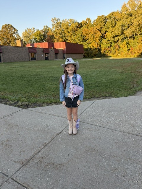 little girl wearing a cowboy outfit
