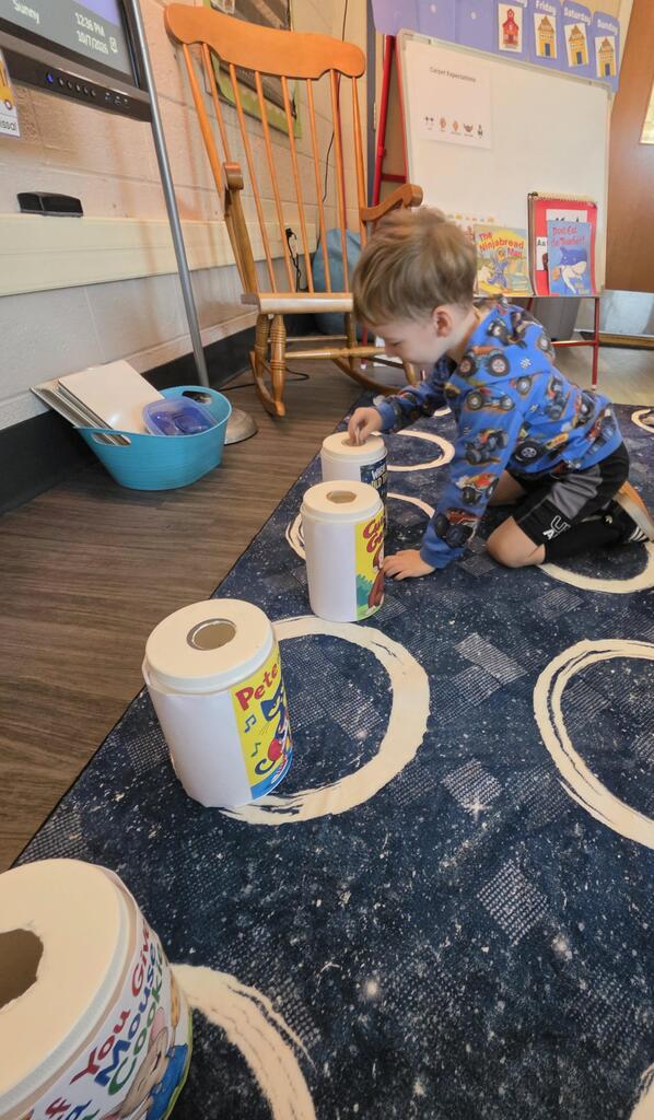 little boy putting a ticket in a jar