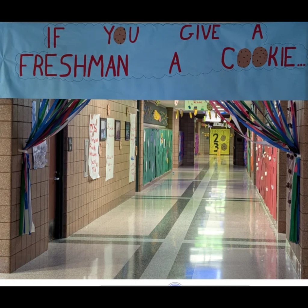 a decorated school hallway with a large banner that says If You Give a Freshman a Cookie
