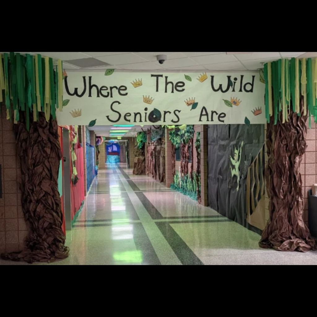 a decorated school hallway with a large banner that says Where The Wild Seniors Are