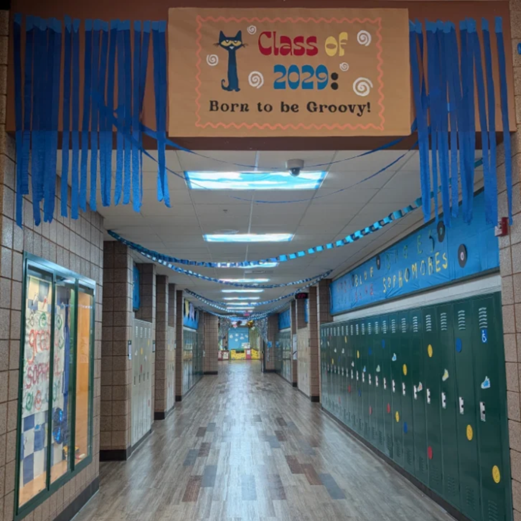 a decorated school hallway with a large banner that has Pete the Cat on it and says Class of 2029: Born to be Groovy