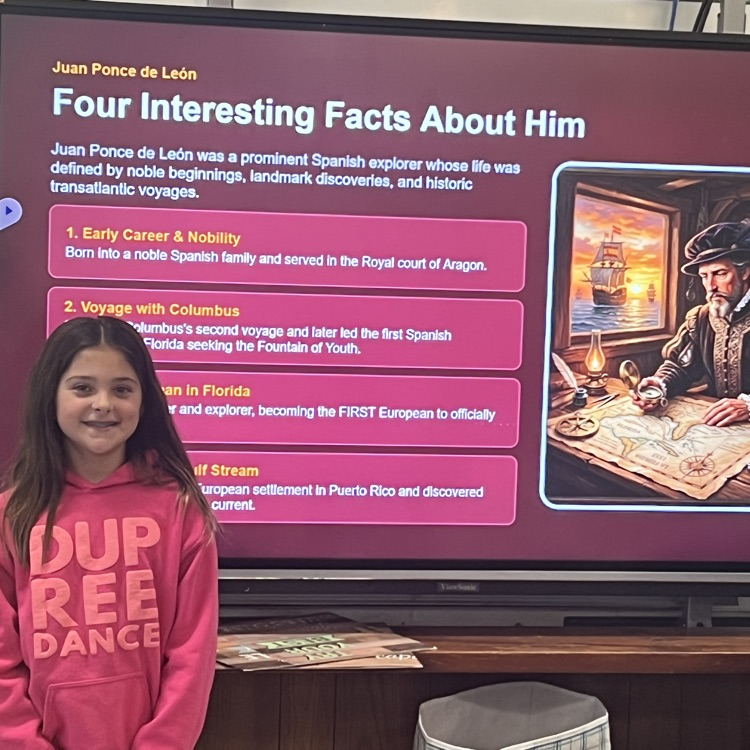 girl standing next to a smart board with facts about Ponce de Leon