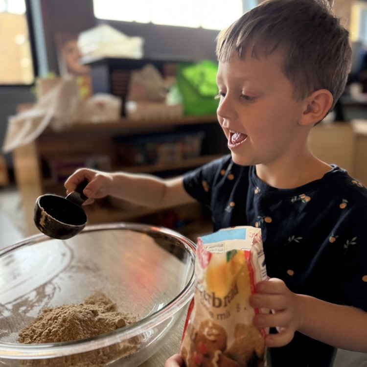 preschooler making gingerbread cookies